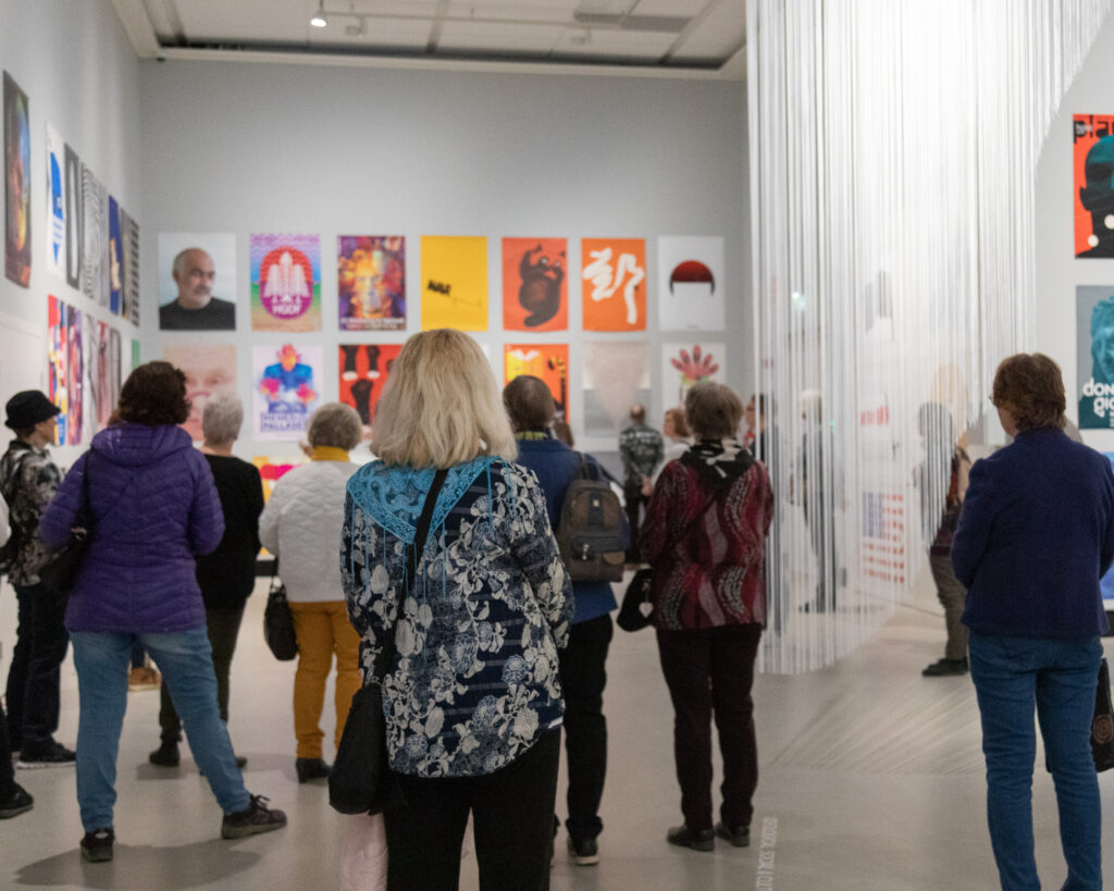 Group of people looking at posters.