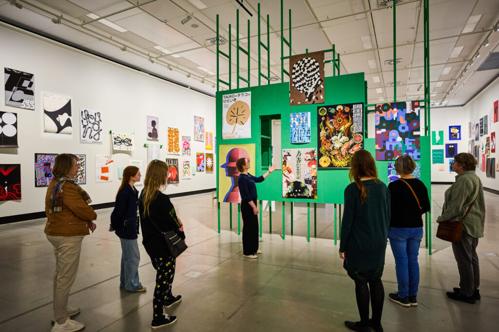Group of people looking at posters.
