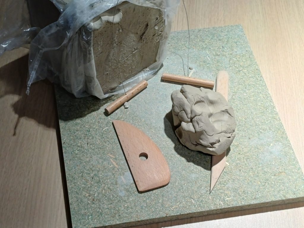 Savesta tehty teos ja ympärillä on työvälineitä.